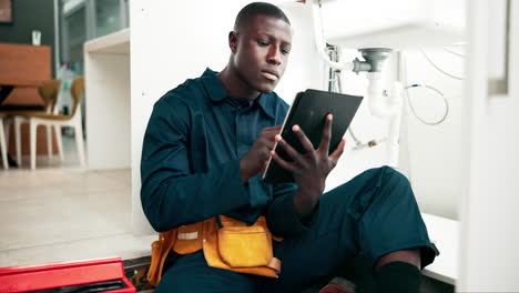 plumber using tablet to repair sink
