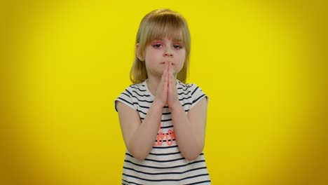 kid child girl praying, making wish, asking with hopeful imploring expression, begging apology