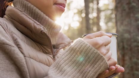 woman drinking coffee in a forest