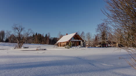 timelapse of quaint winter log cabin surrounded by snow with shadows of trees passing by on the ground