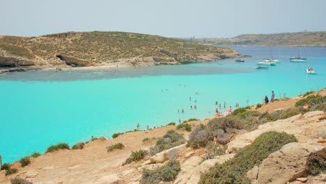 blue lagoon, comino, malta – aerial shot of a busy blue lagoon filled with ships