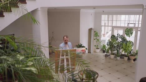 man painting in art studio