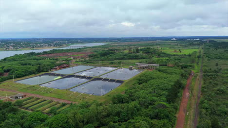 aerial view of wastewater treatment plant on the bank of a river in an urban area. argentina. 4k