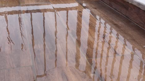 water on a wooden patio floor