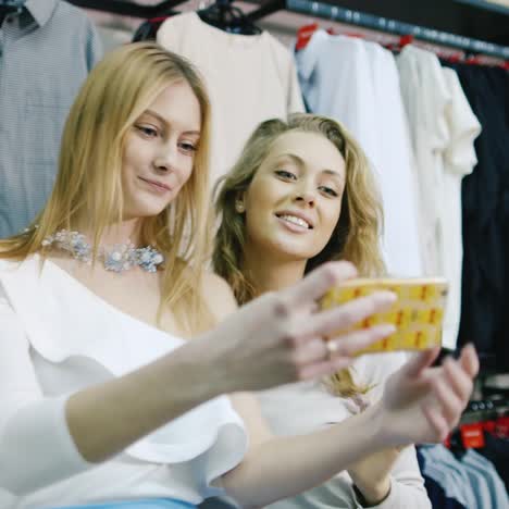 friends take photos in a clothing store fun shopping 1