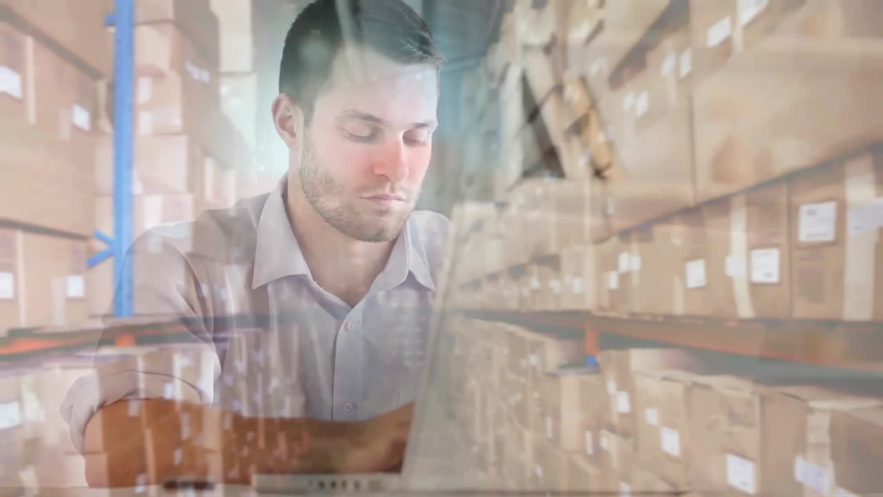 Animation of man typing on laptop keyboard with stacks of boxes in warehouse