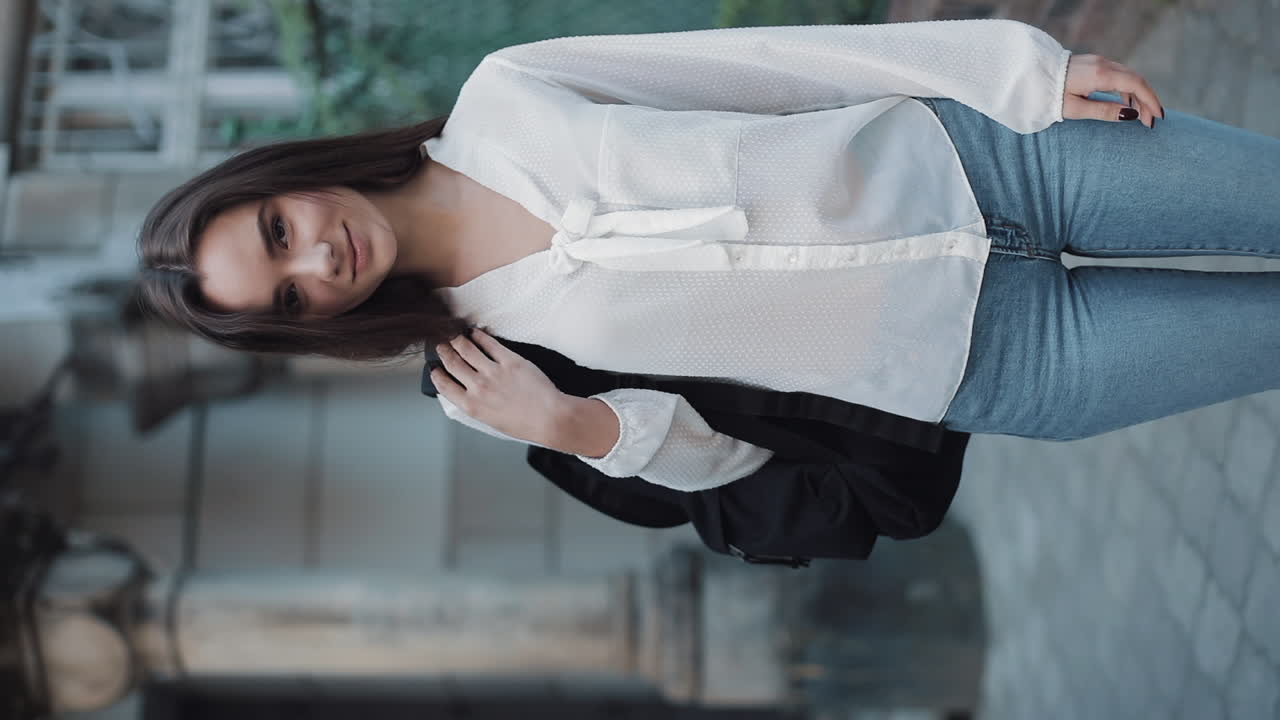 Woman in white blouse and jeans with a backpack