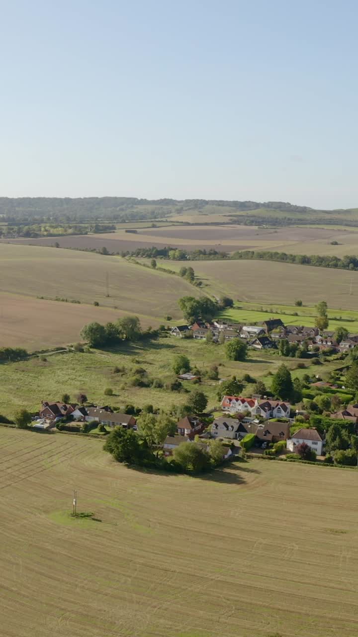 Aerial vertical pass over farmland in Britain showing tidy rows and natural green barriers