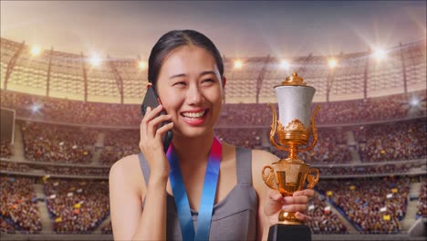 woman celebrating victory with trophy in stadium