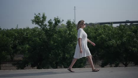 woman walking in an orange grove
