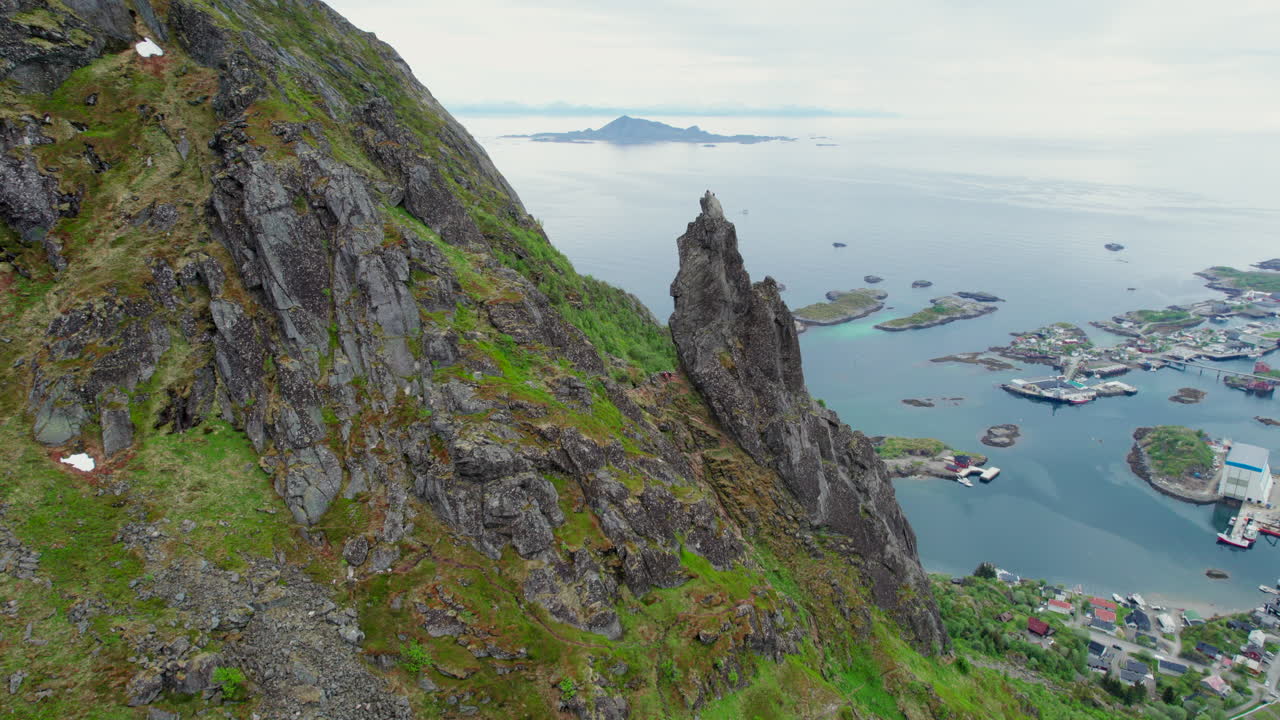 Floya Mountain, featuring the iconic Svolvargeita pinnacle, overlooks the picturesque fishing village of Svolvar in the Lofoten Islands, Norway