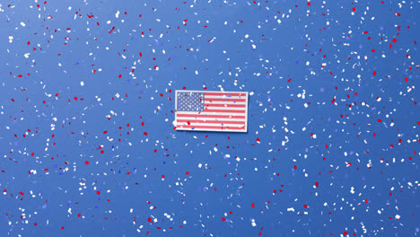 animation of confetti falling over flag of united states of america on blue background