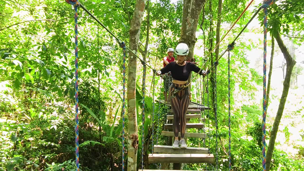 Couple enjoying a treetop adventure park