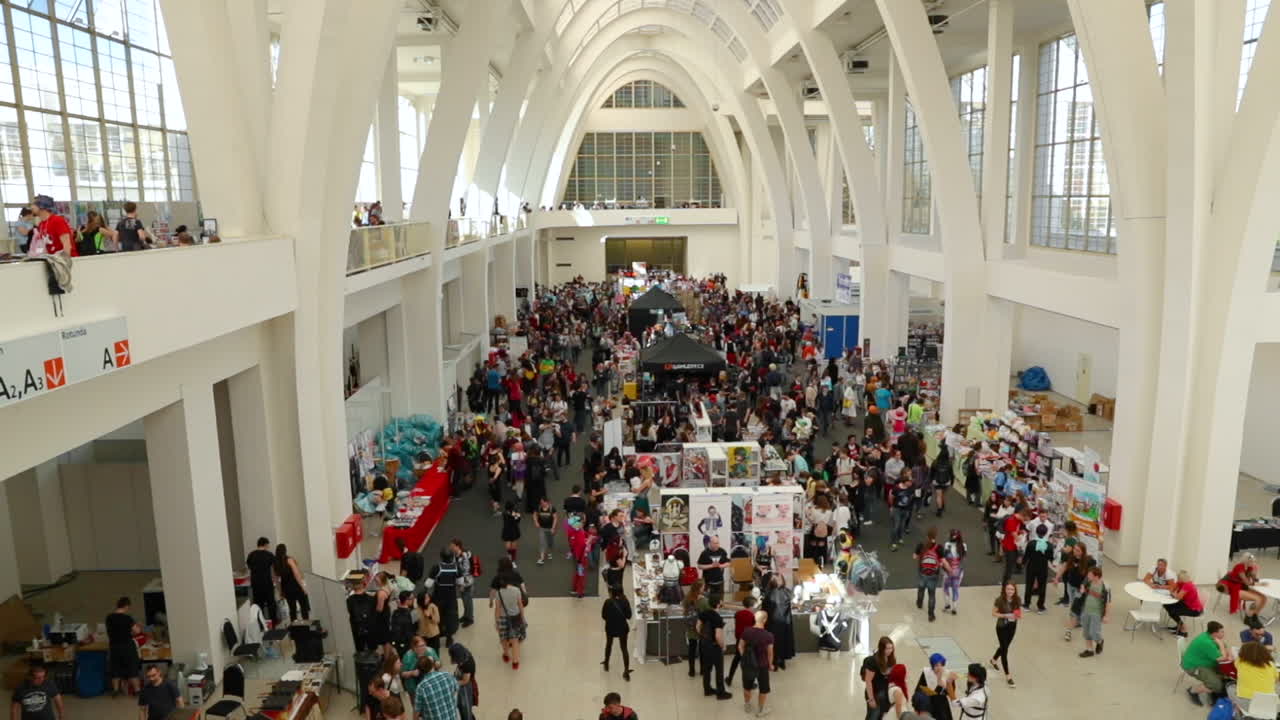From the top view of indoor spaces and large groups of people going through the meeting of fans of anime and Japanese manga at the Animefest event in Brno at the exhibition in 120fps.
