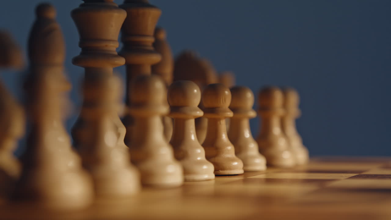 Chessboard white figures closeup under bright sunlight. Pieces tactical force