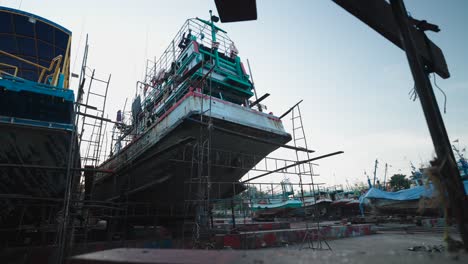 fishing boats under repair in a shipyard