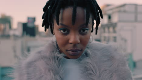 portrait beautiful young african american woman on rooftop at sunset wearing stylish fashion looking confident in urban city