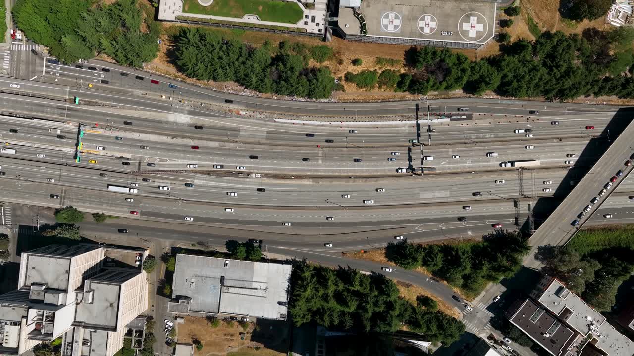 Aerial time lapse of cars driving along the freeway through Seattle's downtown neighborhood