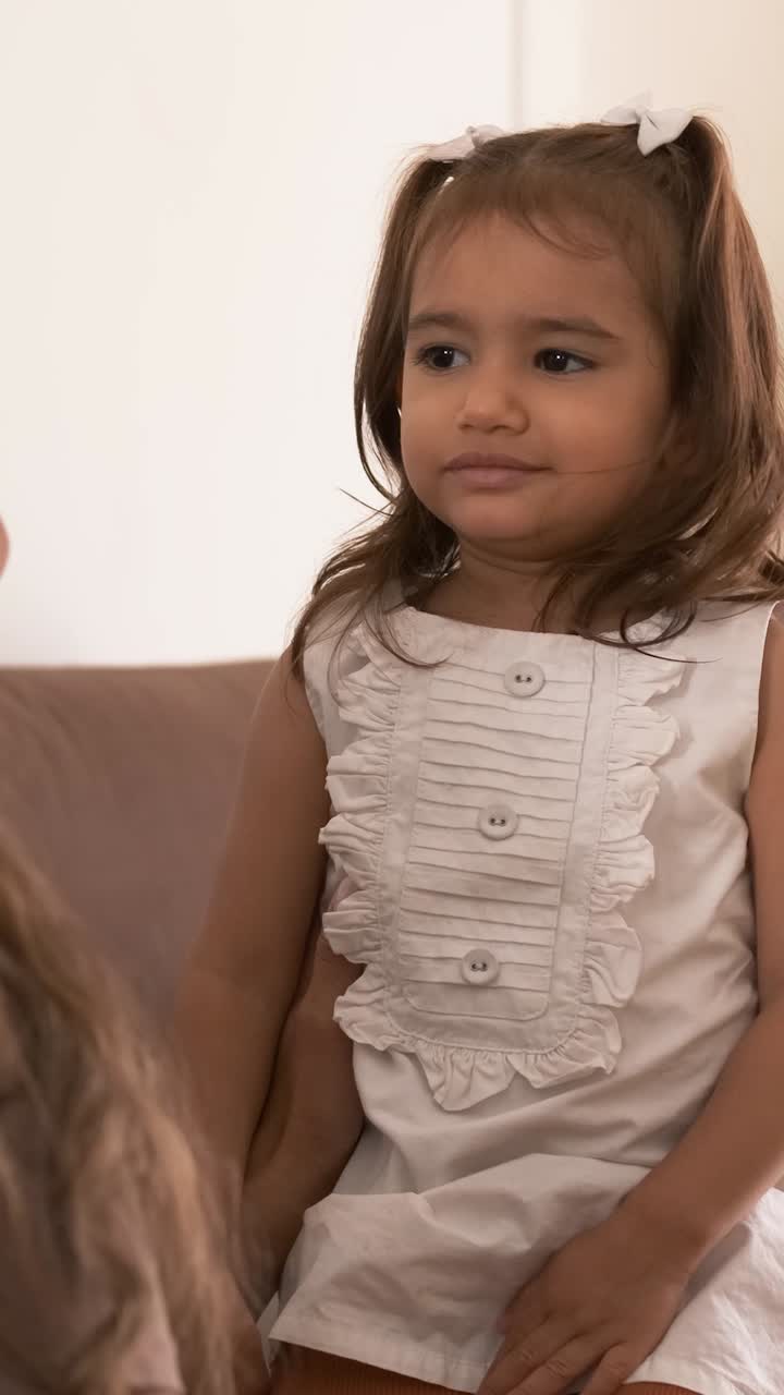 Happy mother and daughter hugging and kissing at home