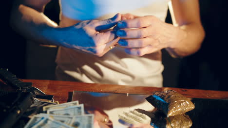 Gangster holding a folded bill for sniffing and snorting the line. Criminal business