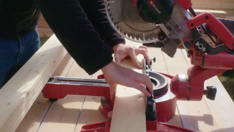 The-craftsman-saws-the-thin-piece-of-wood-to-size
