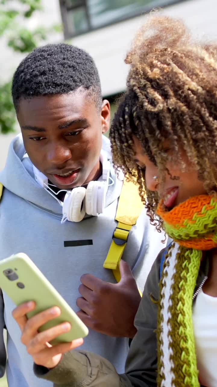 Young adults using a cellphone outdoors