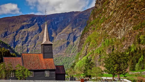 timelapse of clouds passing over beautiful rustic wooden chapel at valley base