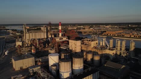 aerial footage of a complex alcohol production plant at sunset in peoria, illlinois