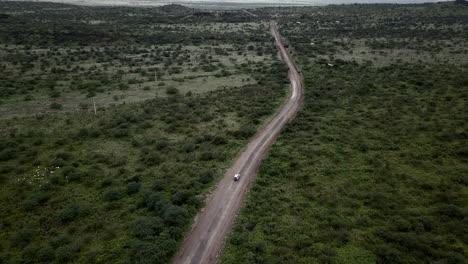 aerial view of a white 4x4 car traveling in east africa