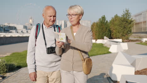 senior couple exploring a city park