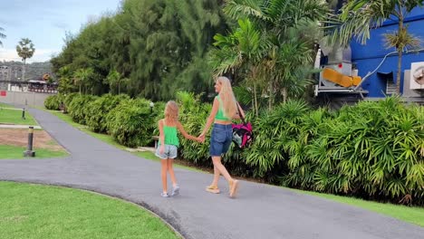 mother and daughter walking in a park