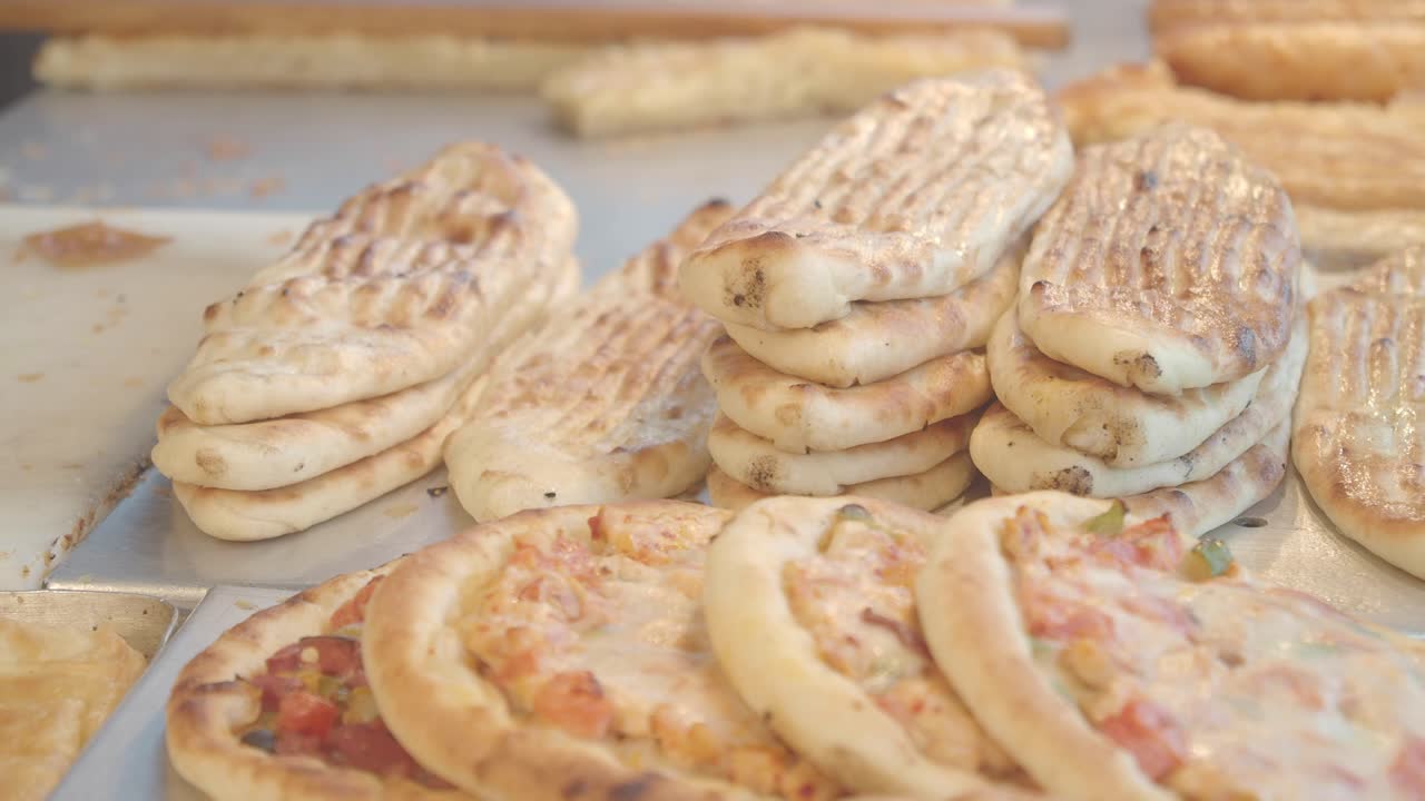 Various Bread and Pizza Dishes on Display