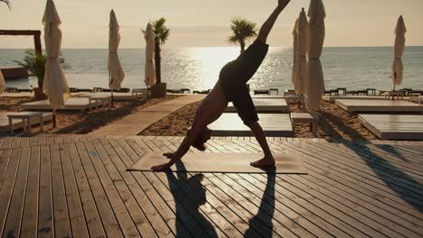 The-guy-pulls-his-legs-up-while-doing-yoga.-Exercises-to-keep-the-body-and-mind-in-good-shape