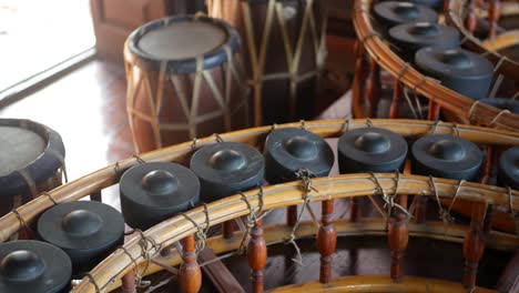 vintage thai style khong wong lek and drums. wooden khong wong lek with gongs and traditional drums placed on wooden floor. thailand music culture objects.