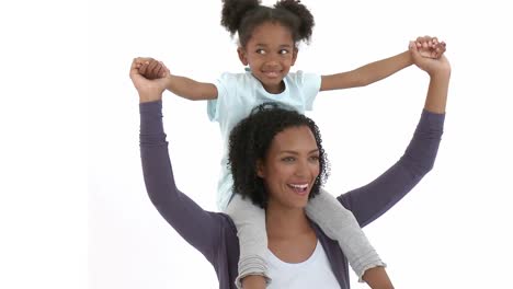 Ethnic-mother-giving-her-daughter-piggyback-ride