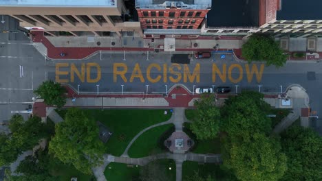 end racism now slogan painted on city street in usa