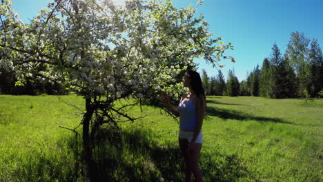 Young woman holding a flower in the grassland 4k
