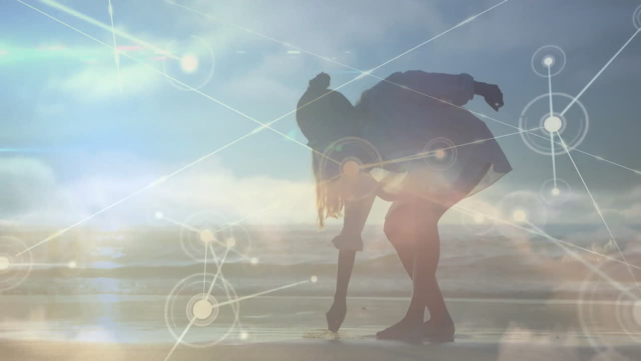 Silhouette of person on beach with network connections animation overlay