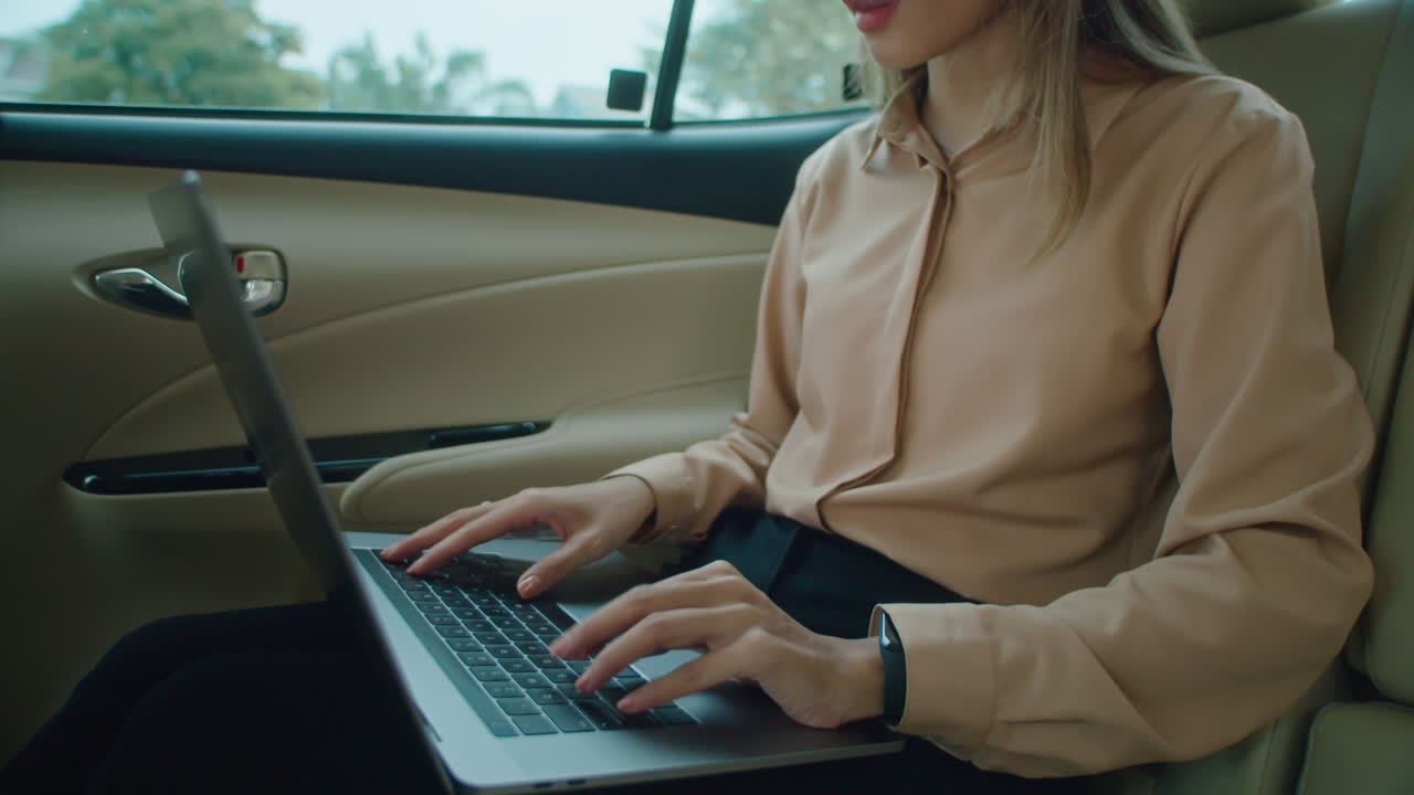 Asian Businesswoman Working on Laptop in Taxi