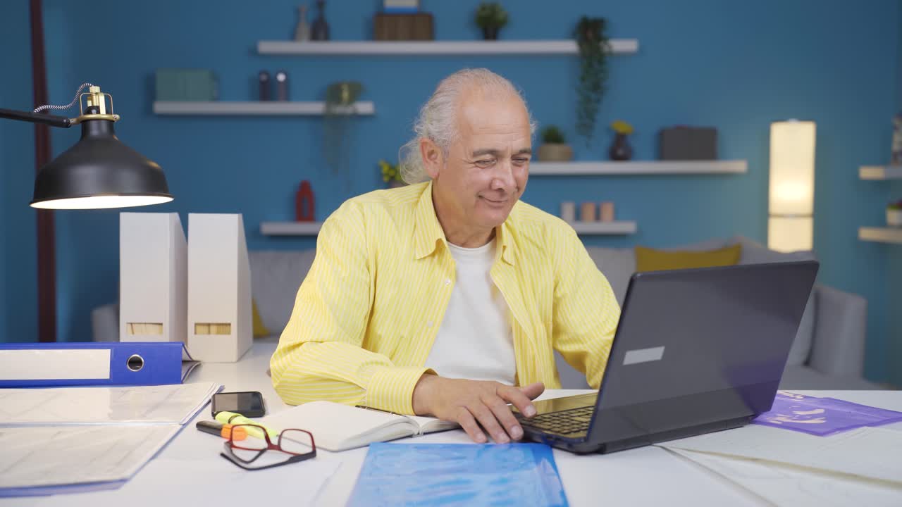Home office worker old man looking with satisfied expression.
