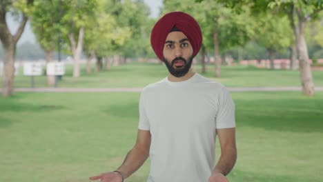 angry sikh indian man fighting with someone in park