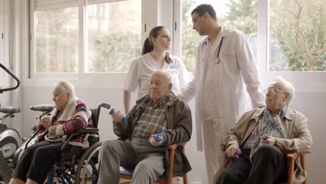distracted doctors talking while senior people exercising in geriatric