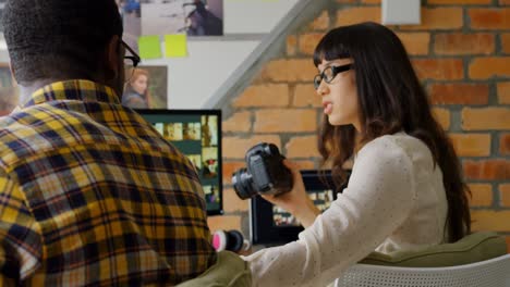 graphic designers working together at desk in a modern office 4k