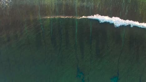 Flying-Over-Breaking-Reef-With-Breaking-Waves