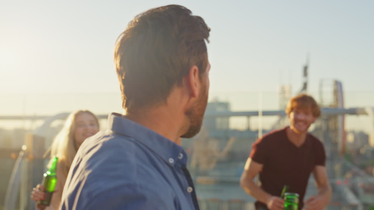 Smiling guy calling celebration at sunny rooftop close up. Happy man talking