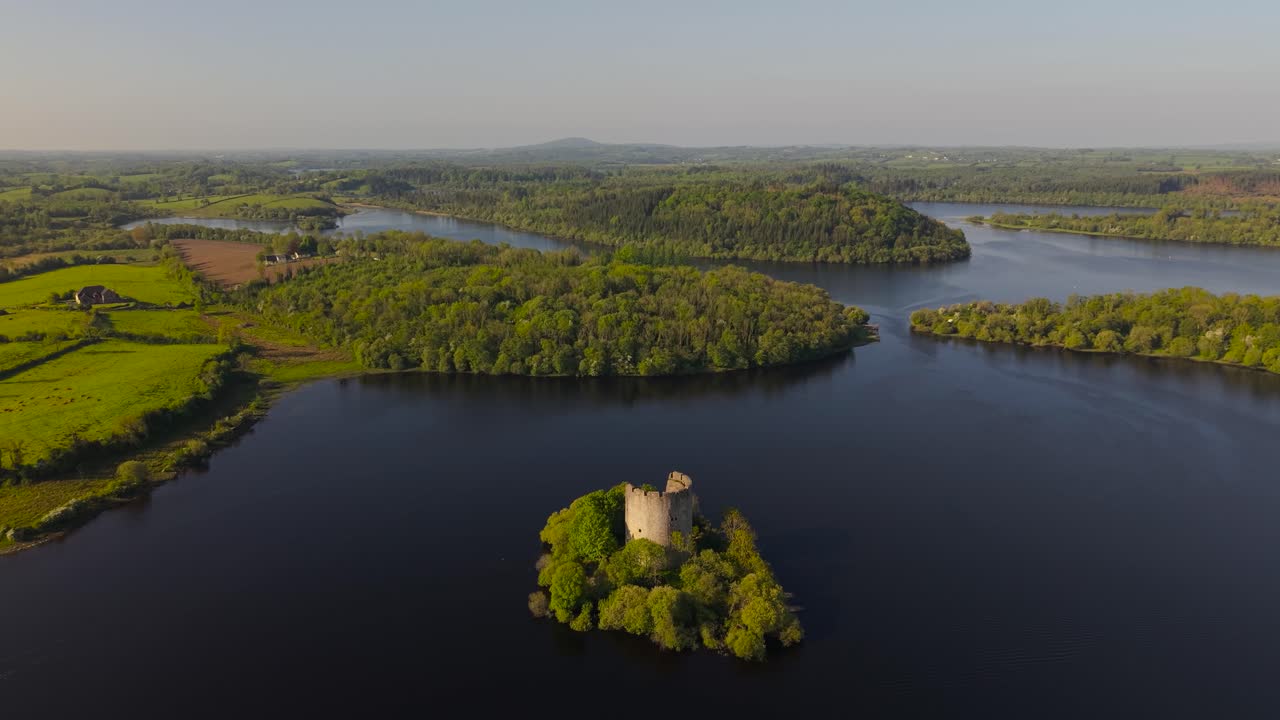 Cloughoughter Castle In Lough Oughter Lake With Green Forest In Killeshandra in County Cavan, Ireland. - aerial pullback shop