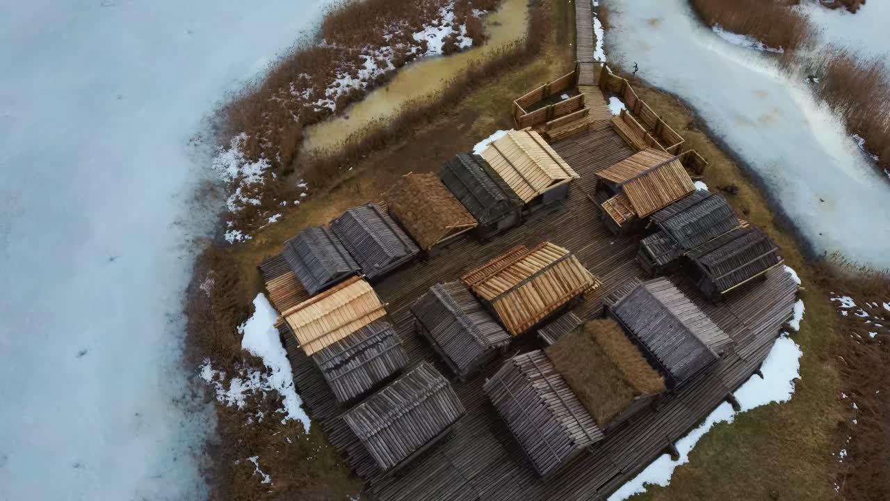 Araisi Lake Castle in Latvia Aerial Shot From Above. Historical Wooden Buildings on Small Island in the Frozen Lake Araisi in the Winter and the Ruins of the Old Medieval Castle