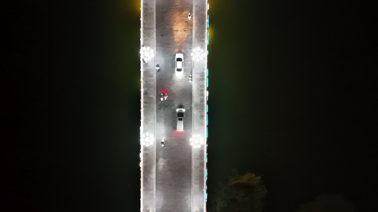 A top-down aerial view of a bridge leading to Lounan Street in Liaocheng, Shandong Province, China.