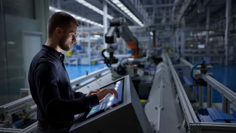 engineer operating a control panel in a modern industrial factory