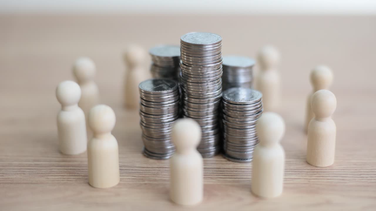 Wooden figures surrounding stacks of coins